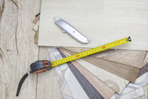 linoleum close-up. Samples and tape measure and cutting knife. There is a tint